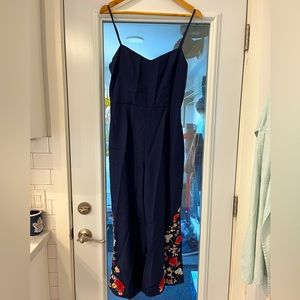 Club Monaco navy blue jumpsuit with embroidery detail.